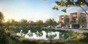 Scenic view of a lush green landscape with a lake, trees, and modern villas in the background at Allure Avani