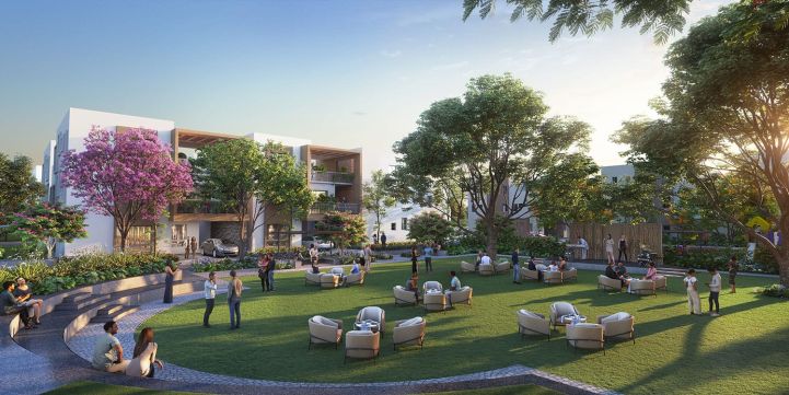 Community open lawn area with seating, lush trees, and residents enjoying outdoor activities.